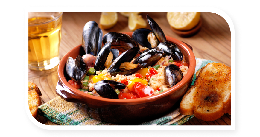 Bowl of cozze in tomato sauce and a huge ciotola of couscous with seafood