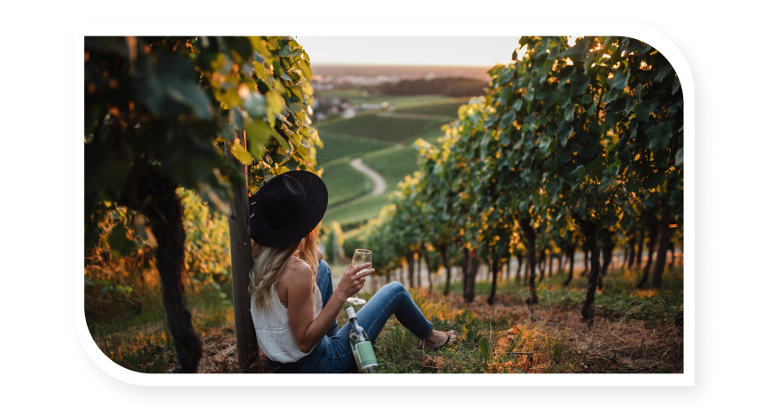 Girl enjoying herself and drinking wine in a vineyard