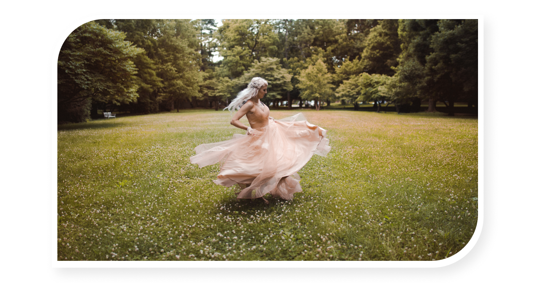 Girl in grass spinning on dress