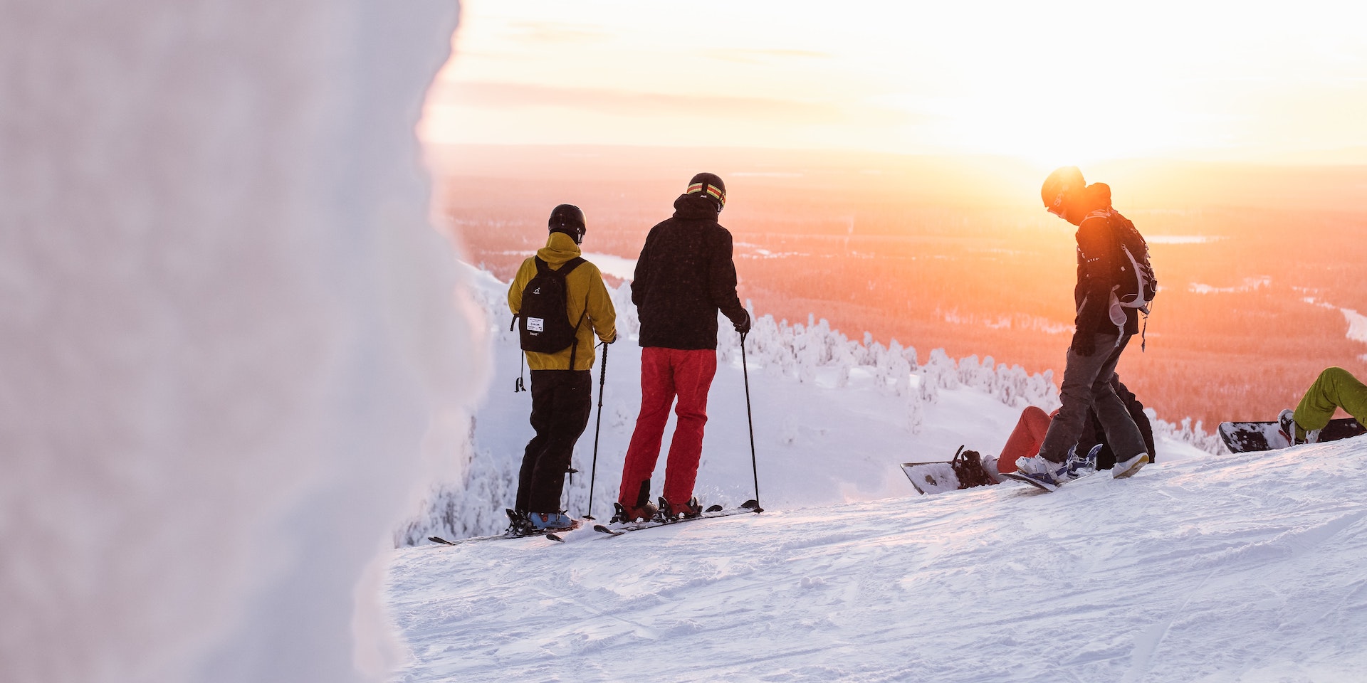 People skiing during sunset